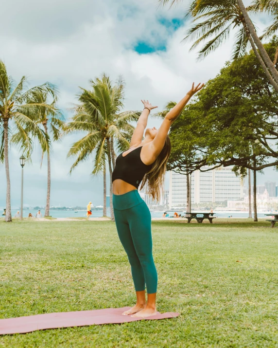 a woman doing a yoga pose in a park, by Maggie Hamilton, pexels contest winner, waikiki beach, arched back, low quality photo, lawn