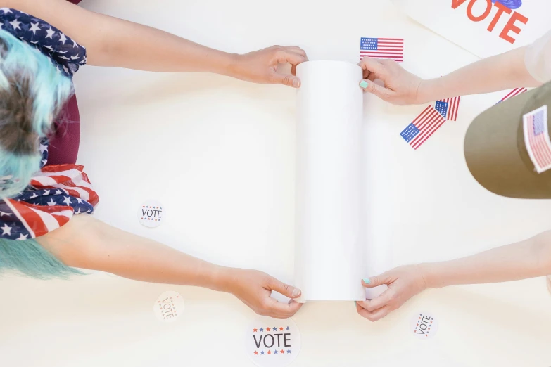 a group of people standing around a table, patriotism, on white paper, fan favorite, four hands