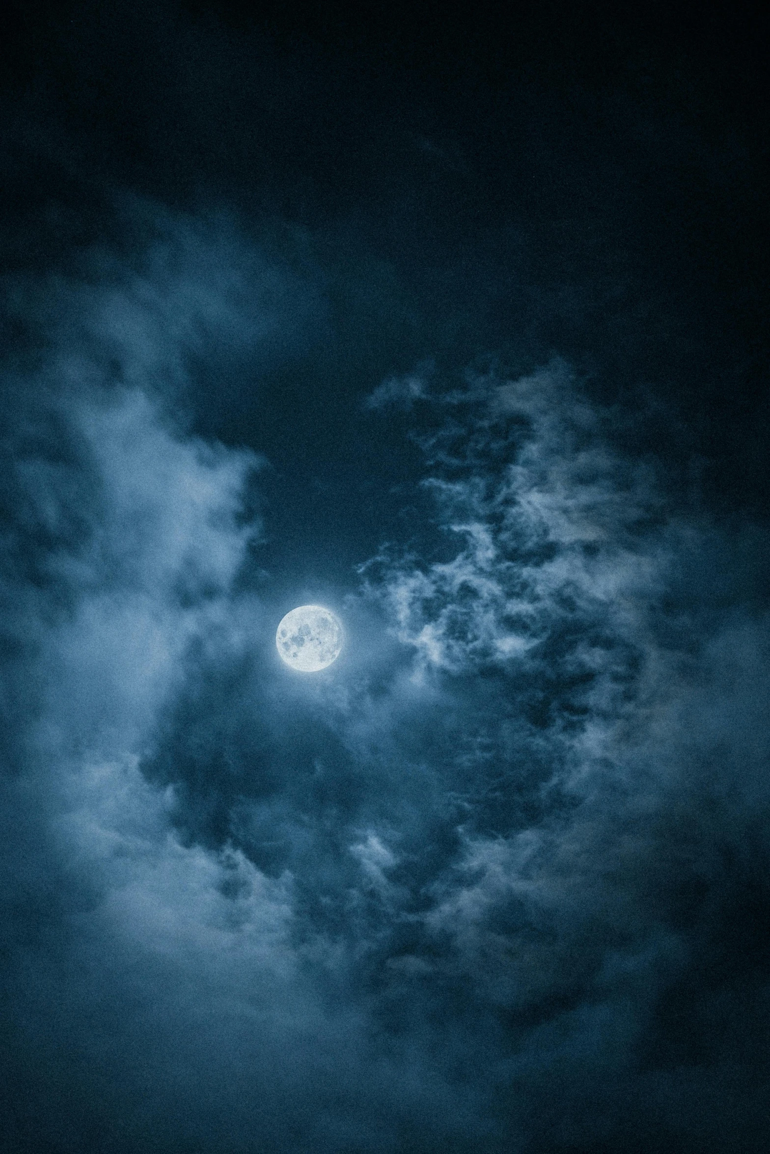 a full moon is seen through the clouds, an album cover, pexels contest winner, night sky; 8k, blue, trending on imagestation, dark photo