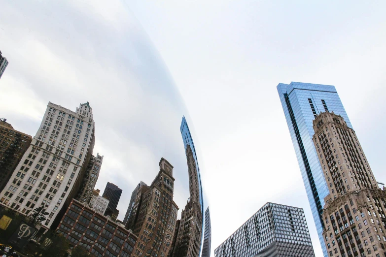 some very tall buildings in a big city, a photo, inspired by Anish Kapoor, pexels contest winner, curved, chicago skyline, metalic reflection, public art