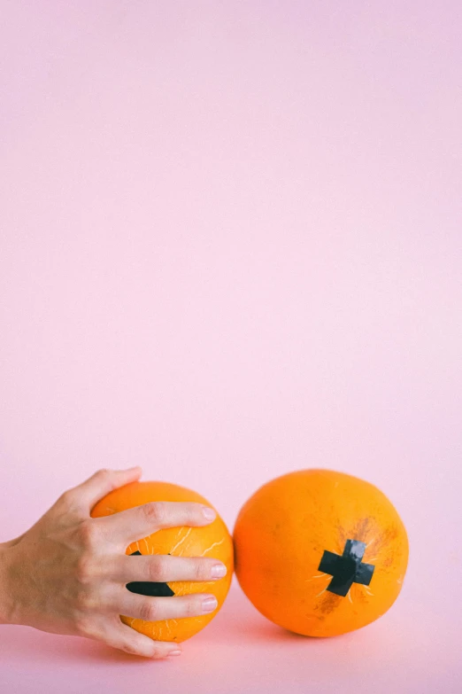 a person holding an orange with a cross on it, by Olivia Peguero, happening, still life photo of a backdrop, skin wounds, coconuts, trending on vsco