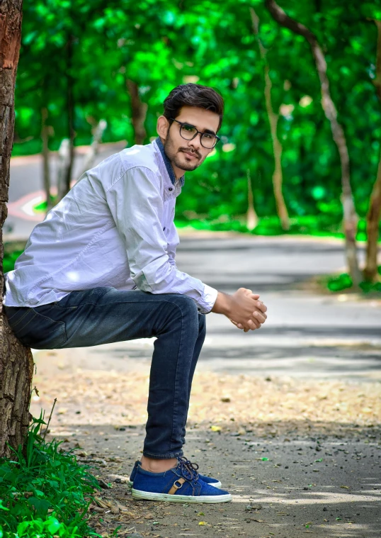 a man leaning against a tree in a park, a picture, inspired by Bikash Bhattacharjee, professional profile picture, indoor picture, handsome, student