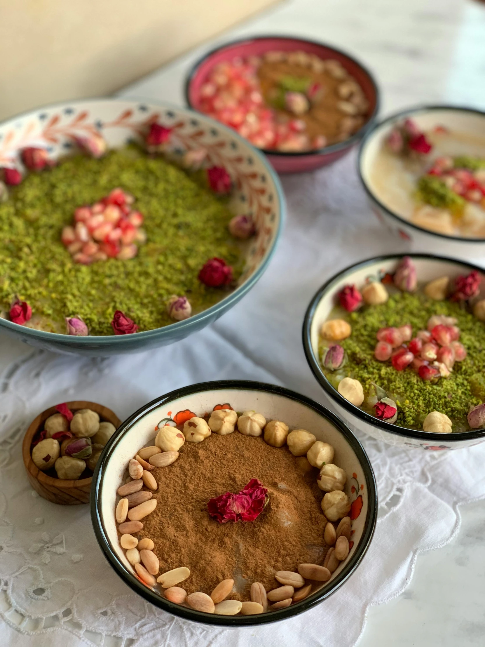 a number of bowls of food on a table, inspired by Taravat Jalali Farahani, dau-al-set, green and red, dessert, medium level shot, greens)