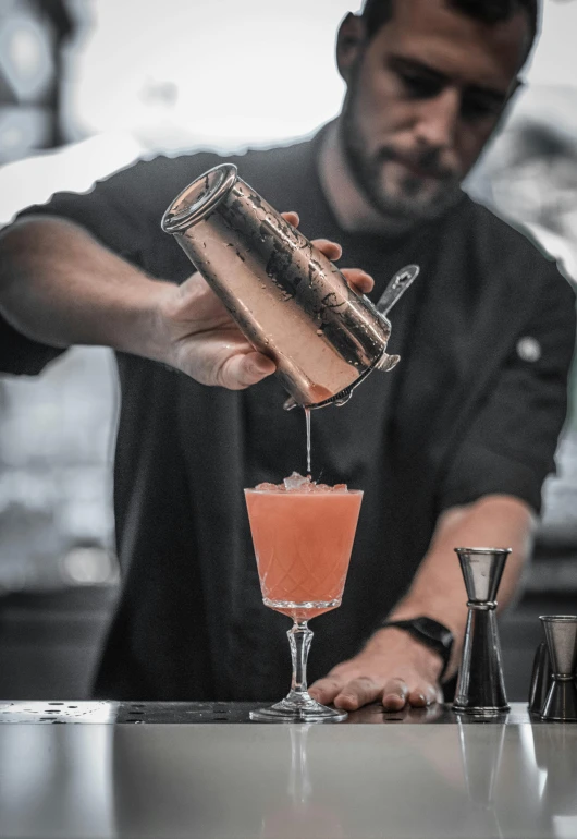 a man is making a cocktail at a bar, pexels contest winner, profile image, skies behind, aussie baristas, extra detail