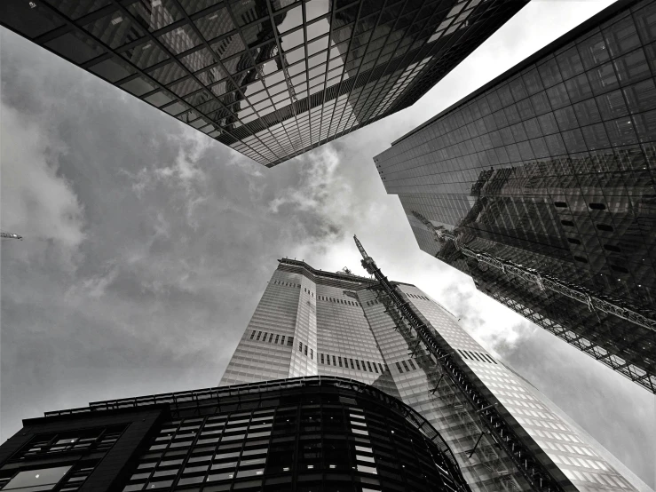 a black and white photo of skyscrapers in a city, pexels contest winner, low angle fisheye view, three towers, photo high definition, new york buildings