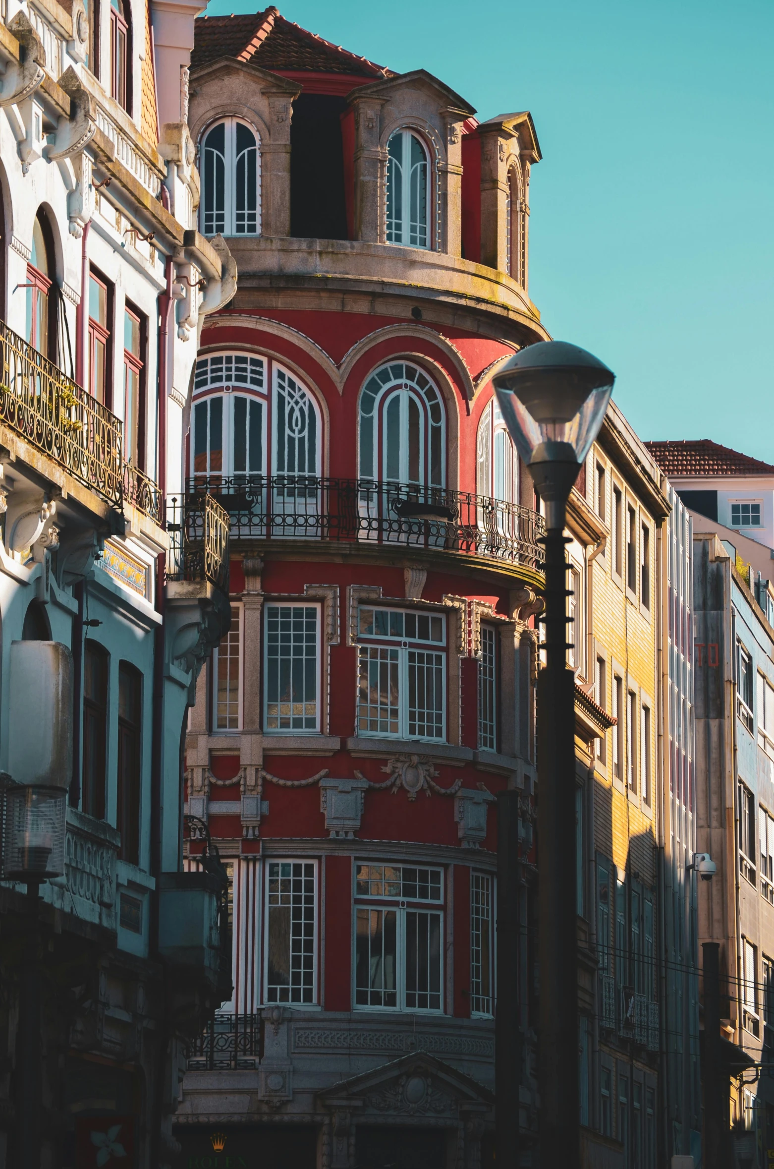 a couple of buildings that are next to each other, by Nadir Afonso, pexels contest winner, art nouveau, colonial, profile image, color”