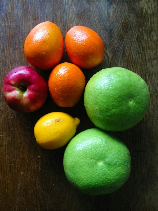 a bunch of fruit sitting on top of a wooden table, thumbnail, uncropped