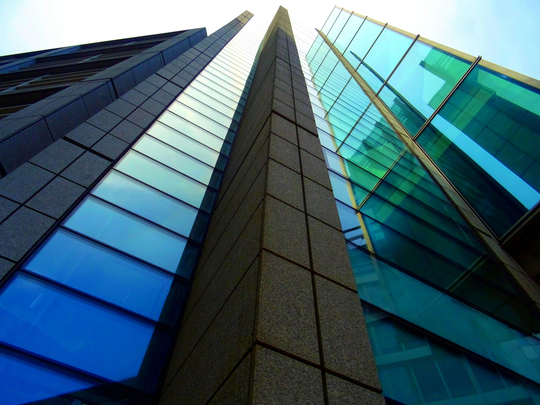 a tall building with a blue sky in the background, flickr, two organic looking towers, refractions, 2 0 0 0's photo, square lines