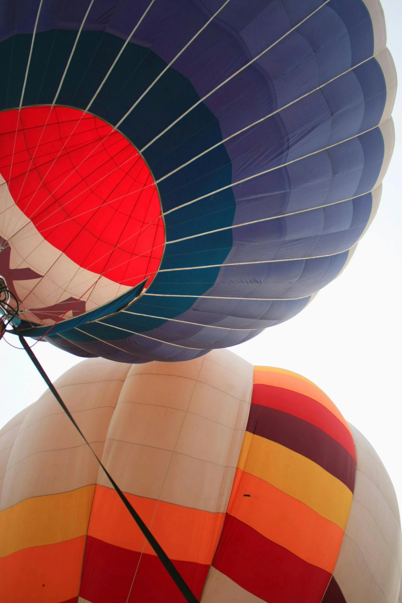 a couple of hot air balloons that are flying in the sky, up close, laos, complimentary colours, helmet view