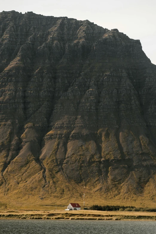 a boat in a body of water with a mountain in the background, a detailed matte painting, inspired by Andreas Gursky, trending on unsplash, hurufiyya, faroe, erosion algorithm landscape, ochre, “ aerial view of a mountain