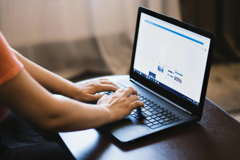 a person using a laptop computer on a table, a computer rendering, by Carey Morris, trending on unsplash, 2 5 6 x 2 5 6 pixels, sydney hanson, link from zelda using computer, wide-screen