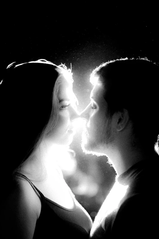 a black and white photo of a man and a woman, a black and white photo, flickr, with backlight, making out, avatar image, uploaded