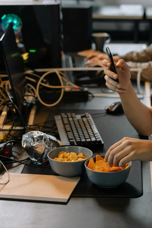 a woman sitting at a desk using a cell phone, by Adam Marczyński, trending on pexels, eating chips and watching tv, pacing in server room, smoking a bowl of hash together, square