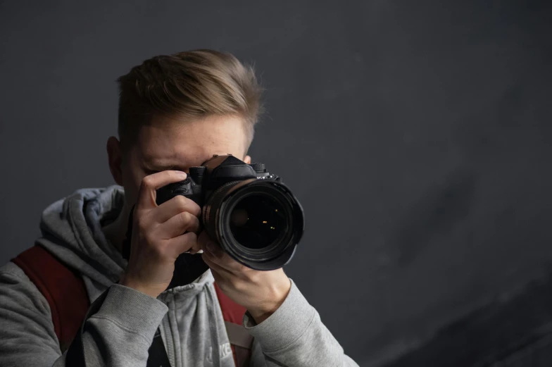 a man taking a picture with a camera, a picture, pexels contest winner, on a gray background, headshot profile picture, photobash, ukraine. professional photo