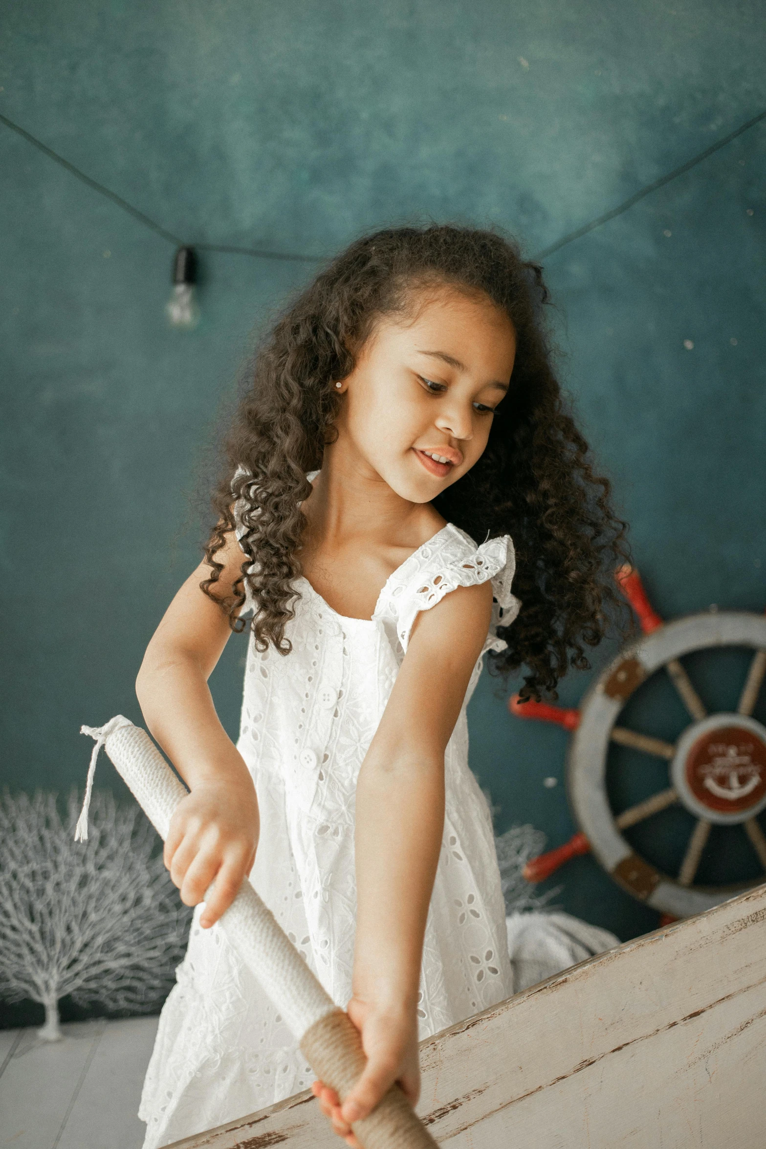 a little girl in a white dress holding a rolling pin, pexels contest winner, long curly black hair, childs bedroom, girl with warship parts, vanessa morgan