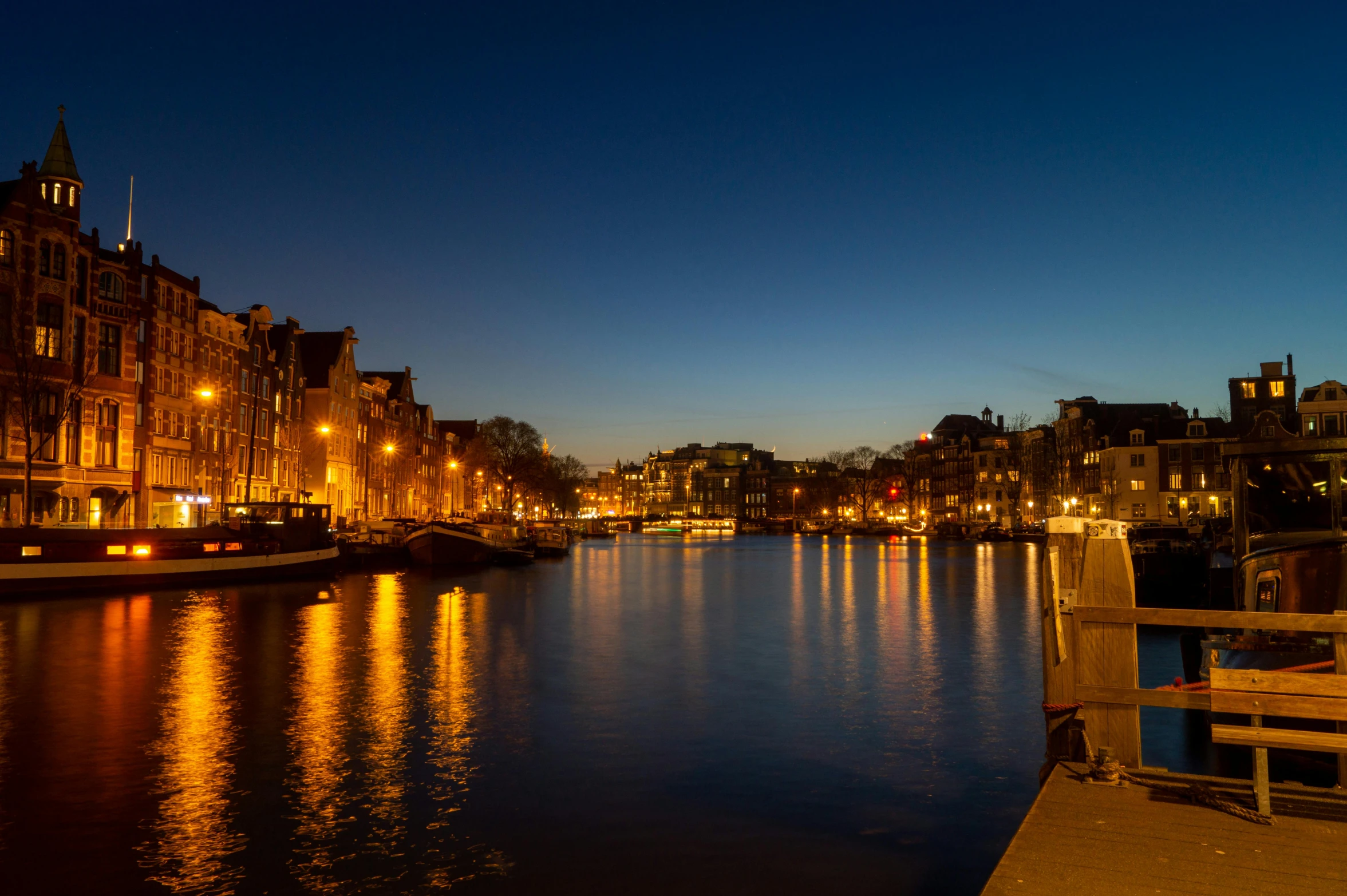 a couple of benches sitting next to a body of water, by Jan Tengnagel, pexels contest winner, happening, city twilight landscape, blue sky, canal, thumbnail