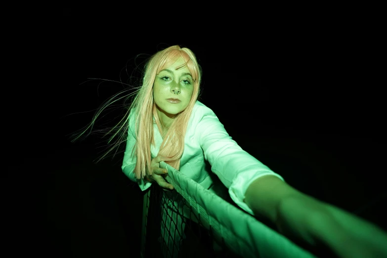 a woman with pink hair standing in the dark, an album cover, inspired by Elsa Bleda, unsplash, cosplay, the grudge, on a bridge, green light