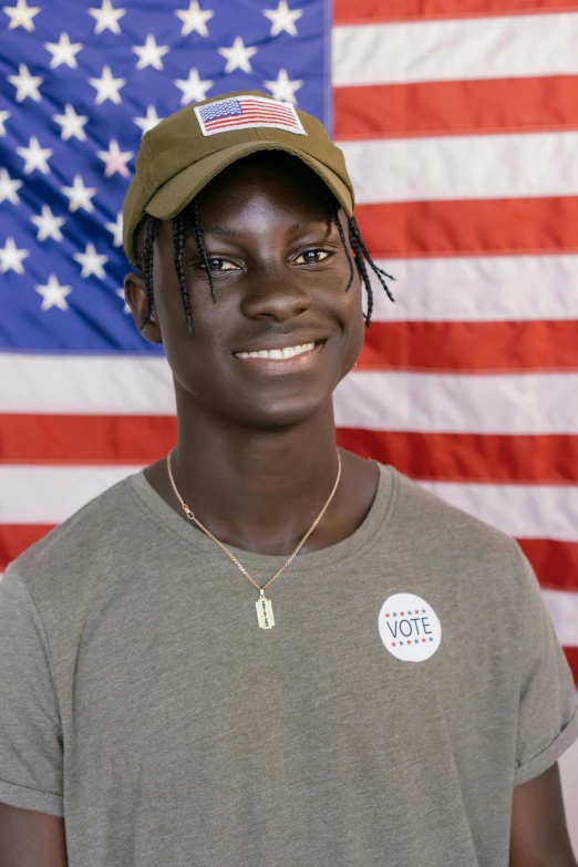 a man standing in front of an american flag, adut akech, profile image, heavily upvoted, proud smile