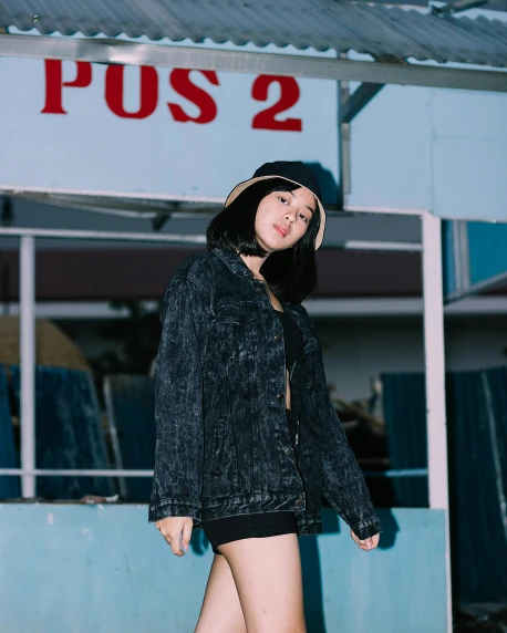 a woman standing in front of a bus stop, an album cover, unsplash, realism, denim jacket, asian women, black on black, poolside