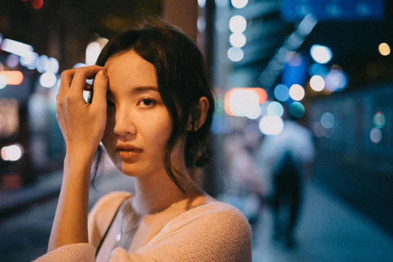 a woman standing on a city street at night, pexels contest winner, hyperrealism, young cute wan asian face, wide forehead, bokeh. rule of thirds, sangsoo jeong