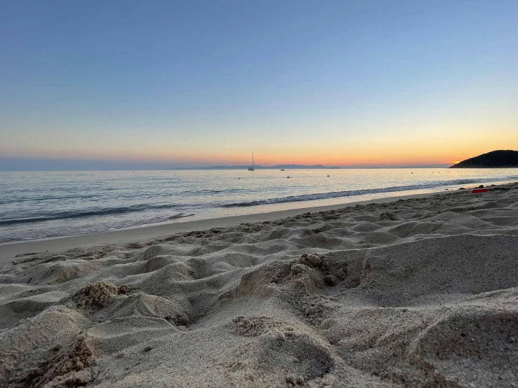 a beach filled with lots of sand next to the ocean, a picture, by Robbie Trevino, as the sun sets on the horizon, marbella, profile pic, sand banks