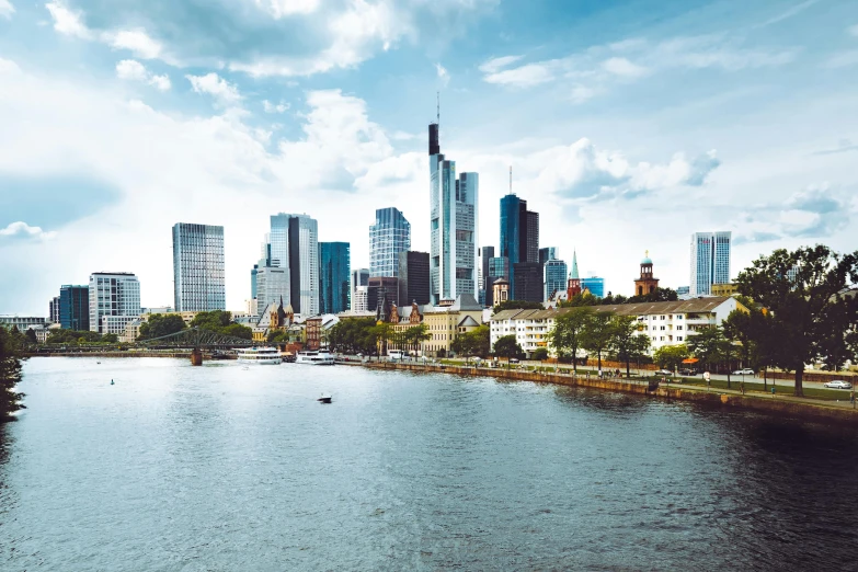 a river running through a city next to tall buildings, pexels contest winner, german romanticism, skyline showing, datapipeline or river, city views, summertime