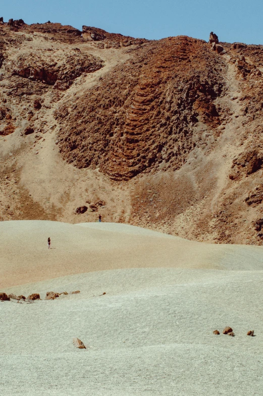a person is flying a kite in the desert, by Alexis Grimou, les nabis, looking down at a massive crater, photo taken on fujifilm superia, tiny people walking below, extreme panoramic