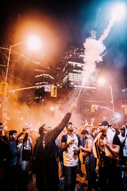 a group of people that are standing in the street, by Niko Henrichon, pexels contest winner, happening, toronto city, firebreathing, party in front, 💣 💥💣 💥