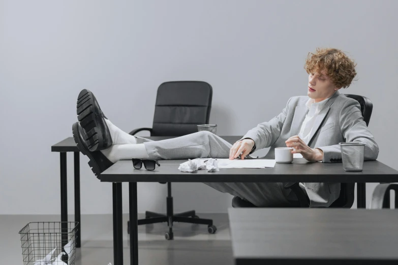 a man sitting at a desk with his feet up, lachlan bailey, short person, office clothes, owen klatte