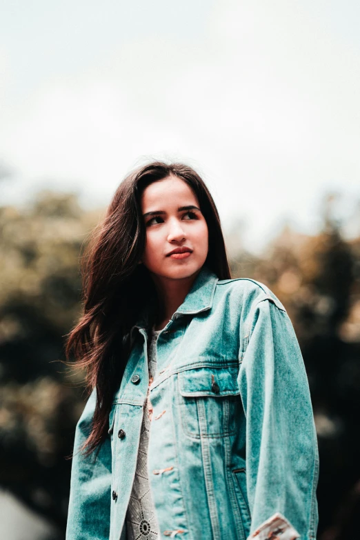 a woman in a denim jacket posing for a picture, an album cover, trending on pexels, young himalayan woman, portrait of sanna marin, slightly smooth, sharpened image