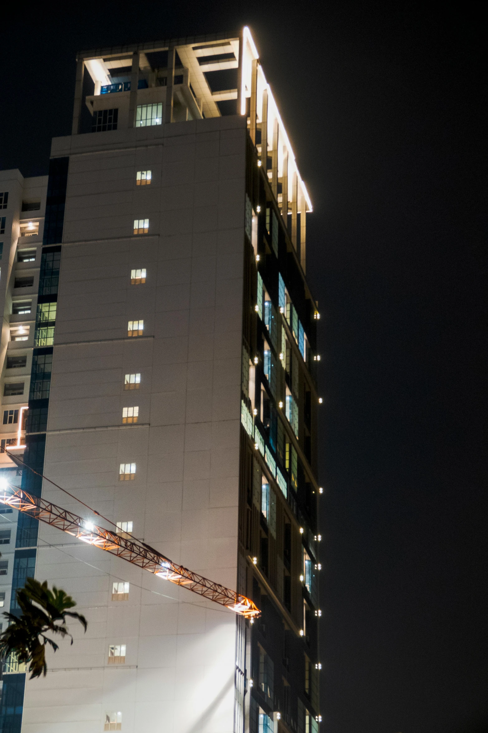 a tall building is lit up at night, 5 th floor, shot on sony a 7, futuristic phnom-penh cambodia