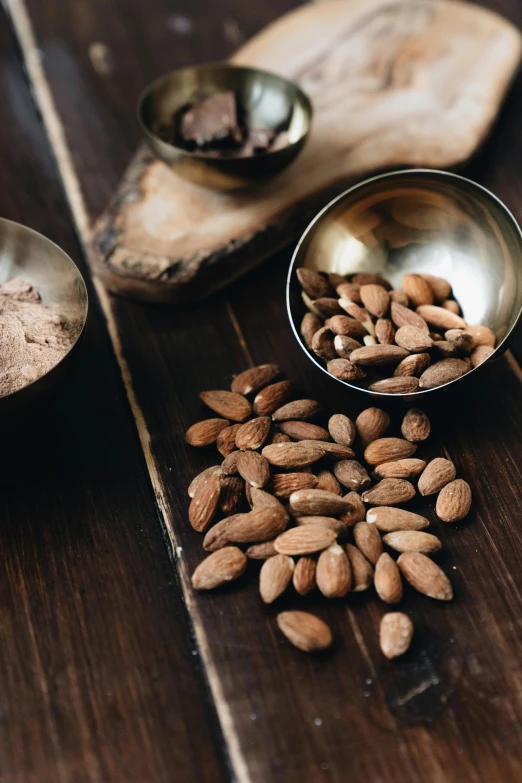 a bunch of nuts sitting on top of a wooden table, detailed product image, ingredients on the table, thumbnail, iron