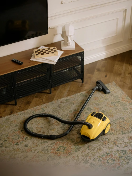 a vacuum sitting on top of a rug in a living room, by Matthias Stom, pexels contest winner, hyperrealism, yellow, celebration, 15081959 21121991 01012000 4k, miniature product photo