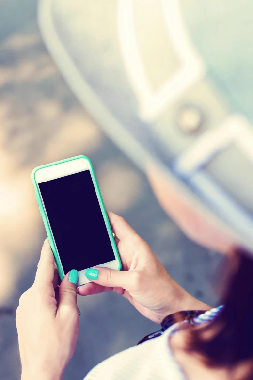 a close up of a person holding a cell phone, a picture, teal, square, afternoon, no text!