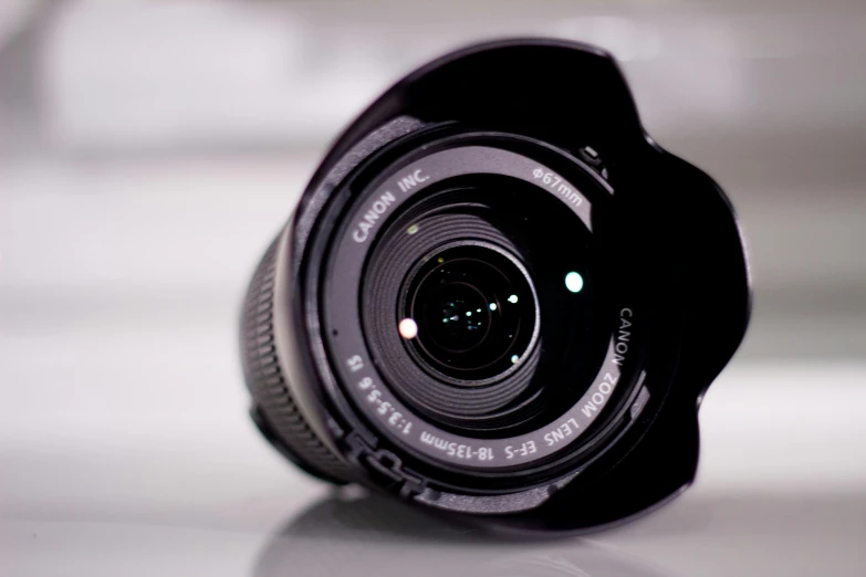 a close up of a camera lens on a table, by Tom Carapic, pexels contest winner, ((fish eye)), 12mm wide-angle, video, wide angle lens. 8 k