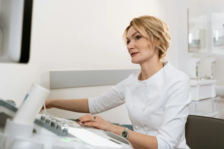 a woman sitting at a desk working on a computer, a photocopy, by Alexander Fedosav, shutterstock, dentist, close up portrait shot, avatar image, 40 years old women