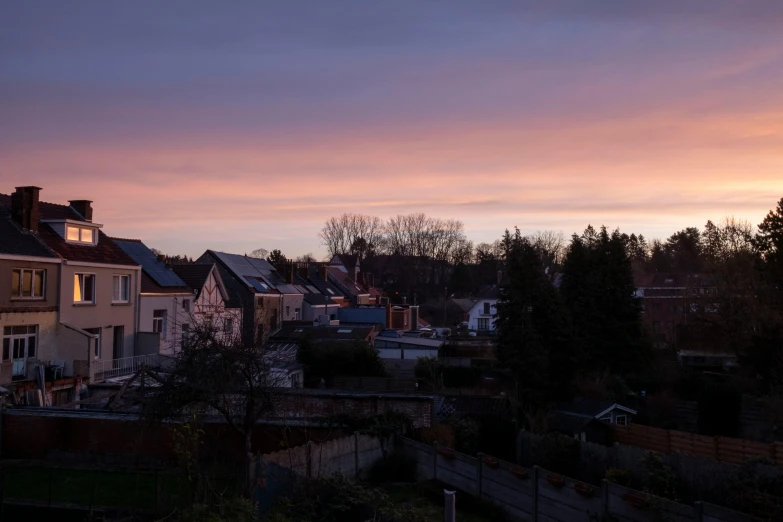 a couple of houses sitting next to each other, by Jan Tengnagel, unsplash, happening, backlight sunset sky, detmold, pink, timelapse