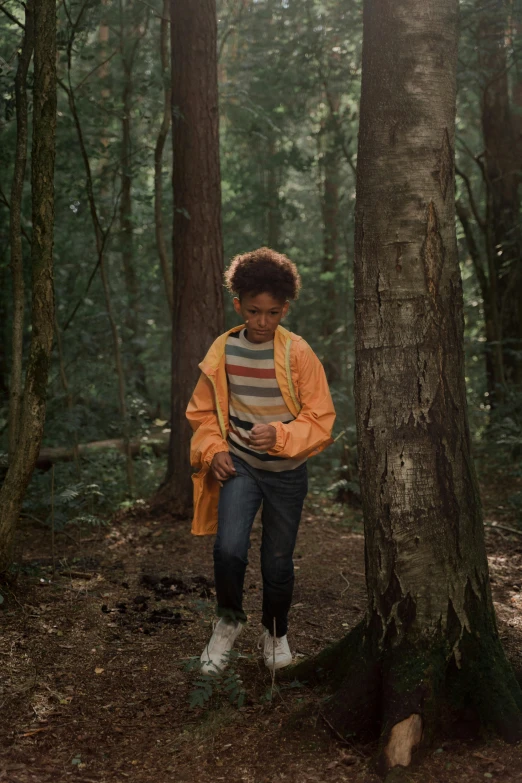 a woman standing next to a tree in a forest, happening, black teenage boy, stranger things character, checking her phone, ( ( theatrical ) )