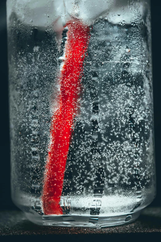 a red straw sticking out of a glass of water, a microscopic photo, pexels, kinetic pointillism, ice dust, bottle, grainy photograph, can