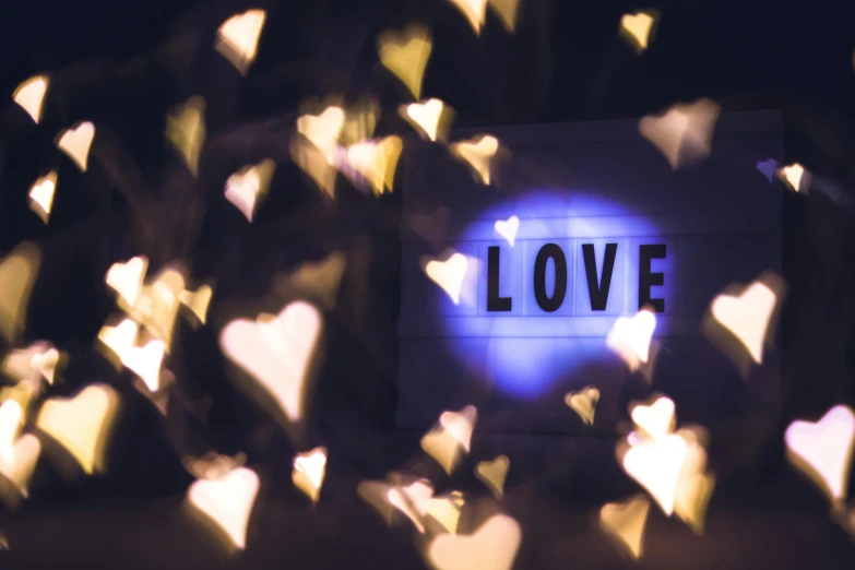 there is a sign with the word love on it, pexels contest winner, ethereal lights, avatar image, cardboard, boke