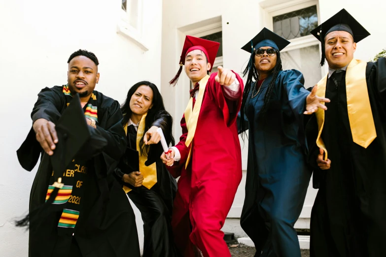 a group of people in graduation gowns posing for a picture, a photo, pexels, diverse costumes, black and yellow and red scheme, childhood friend vibes, music video