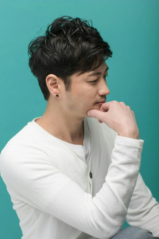 a man that is sitting down with his hand on his chin, an album cover, inspired by Joong Keun Lee, trending on pexels, jc park, headshot profile picture, solid background, mark edward fischbach