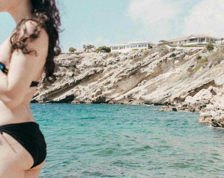 a woman standing on top of a beach next to a body of water, pexels contest winner, les nabis, costa blanca, 💋 💄 👠 👗, close up half body shot, panoramic view of girl