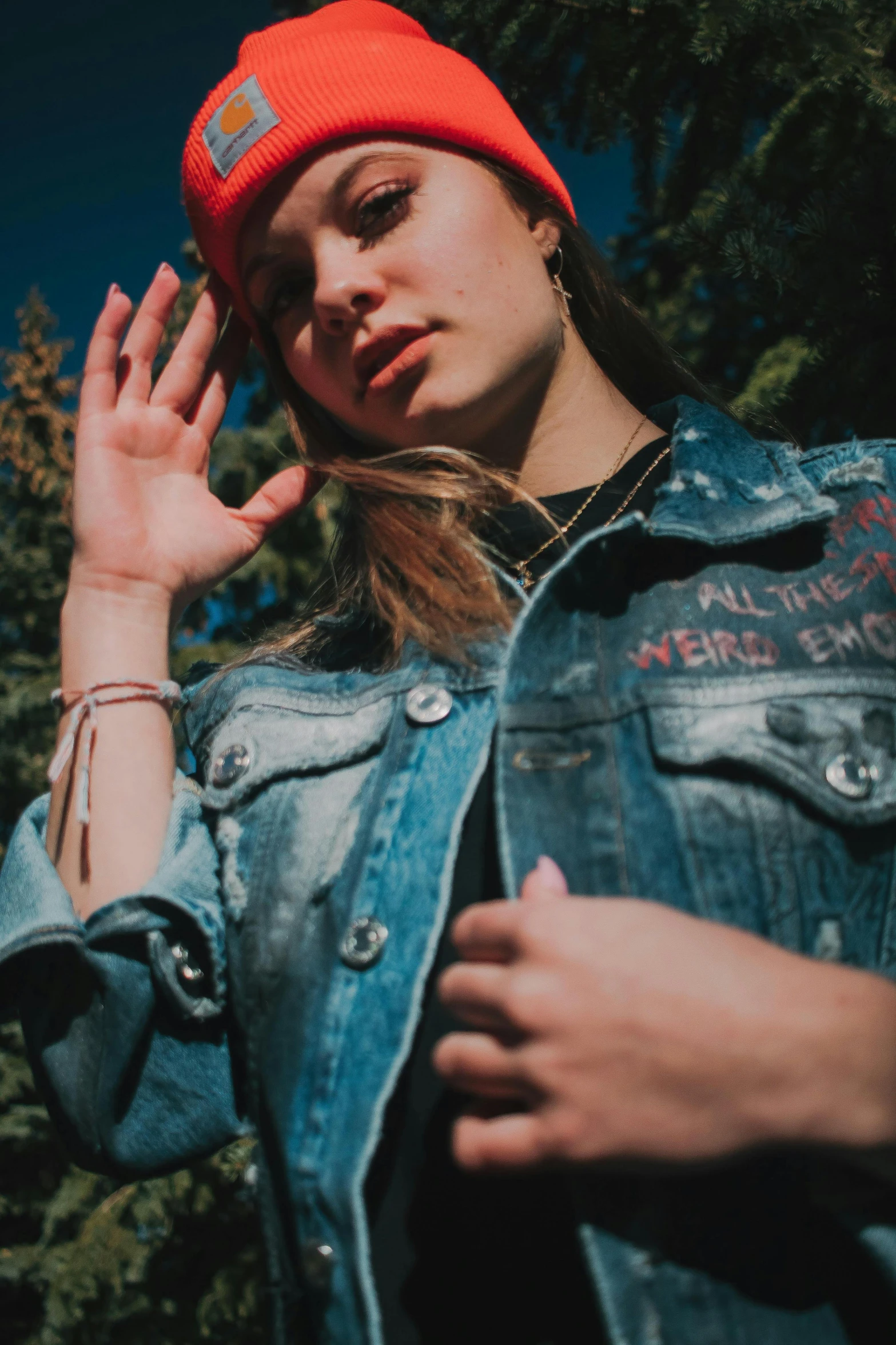 a woman wearing a denim jacket and a red hat, an album cover, inspired by Elsa Bleda, trending on pexels, aestheticism, hand gesture, 👅 👅, ultra high quality model, teenage