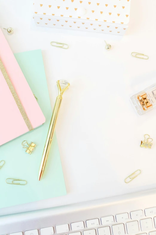 a computer keyboard sitting on top of a white desk, lockpicks and pile of gold, pastel', writing in journal, 9 9 designs