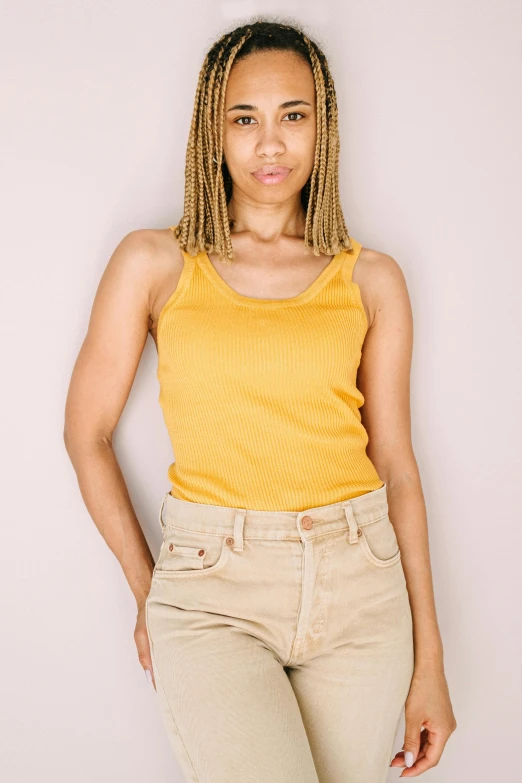 a woman in a yellow tank top posing for a picture, trending on pexels, renaissance, light brown skin!, fullbody photo, promotional image, 2000s photo