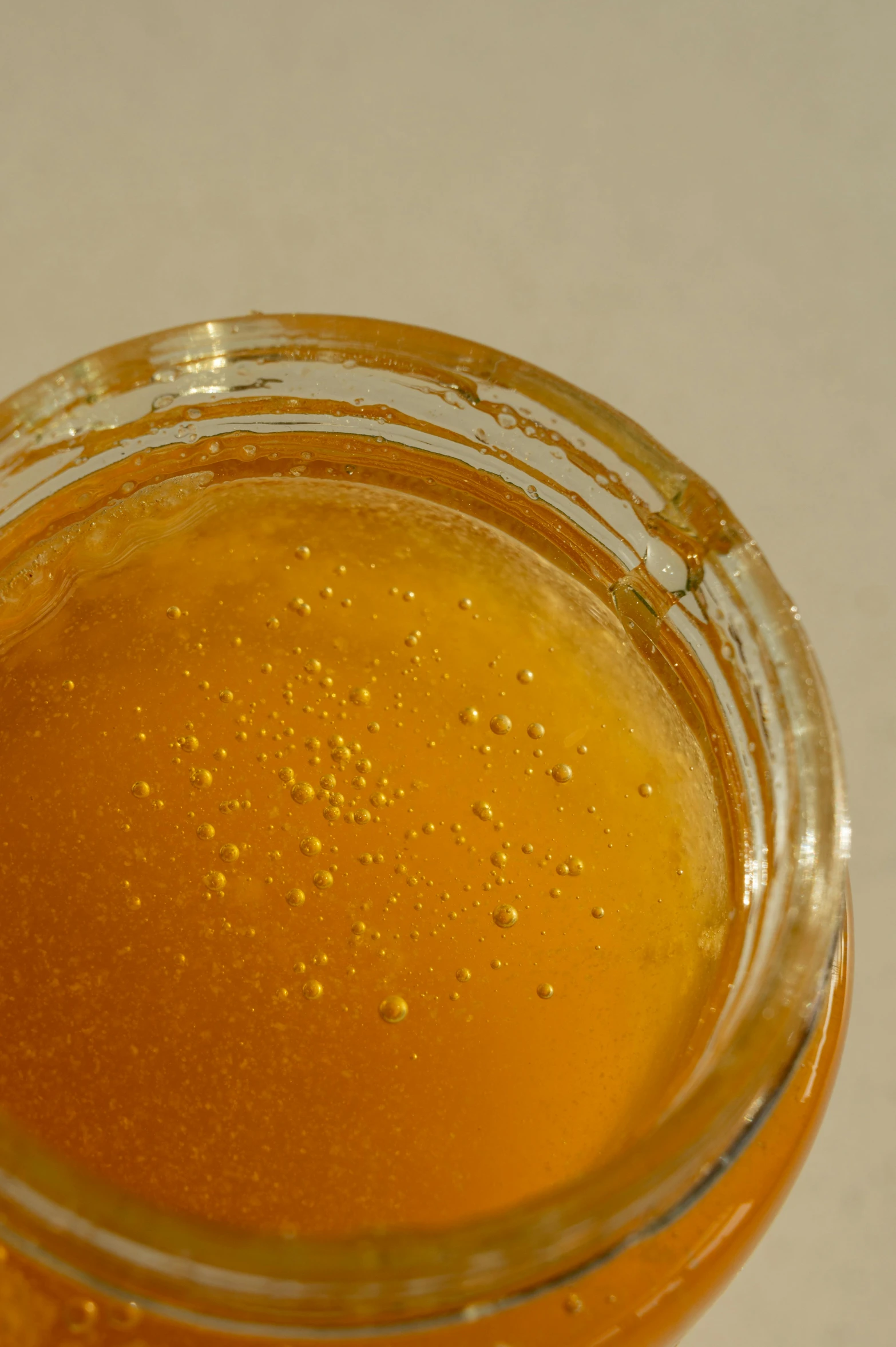 a jar of honey sitting on top of a table, bubbling ooze covered serious, close-up from above, detailed product image, the sour