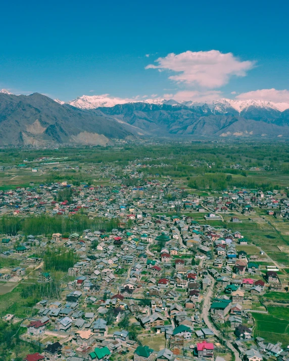 an aerial view of a small town with mountains in the background, pexels contest winner, hurufiyya, background image, india, buds, ash thorp khyzyl saleem