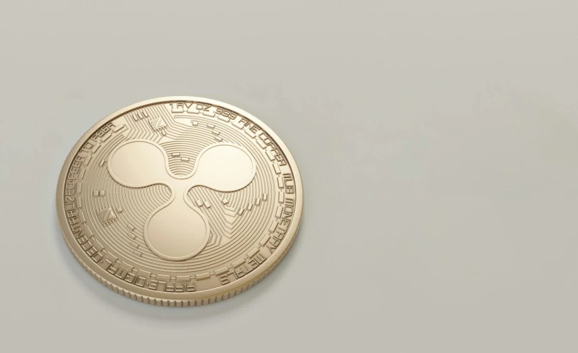 a gold coin sitting on top of a table, ripple, detailed product image, on a gray background, fan favorite