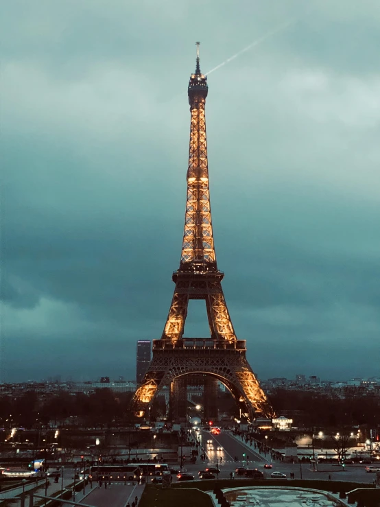 the eiffel tower is lit up at night, pexels contest winner, overcast skies, 🚿🗝📝, instagram story, vintage photo